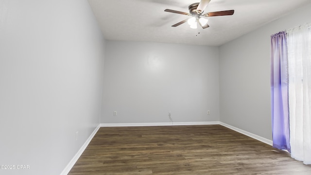 unfurnished room with ceiling fan and dark hardwood / wood-style flooring