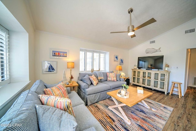 living room with crown molding, vaulted ceiling, dark hardwood / wood-style floors, and ceiling fan