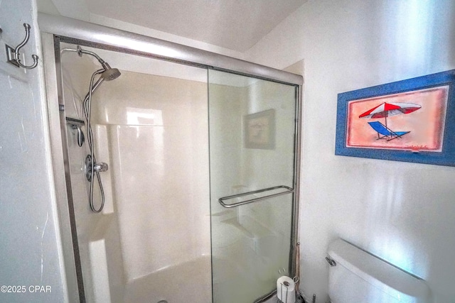 bathroom with toilet and walk in shower