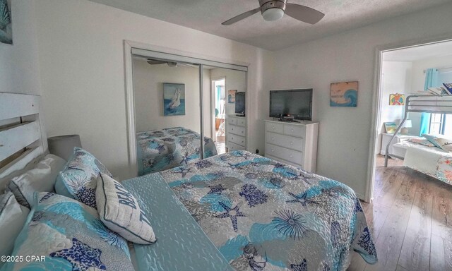 bedroom featuring hardwood / wood-style floors, a closet, and ceiling fan