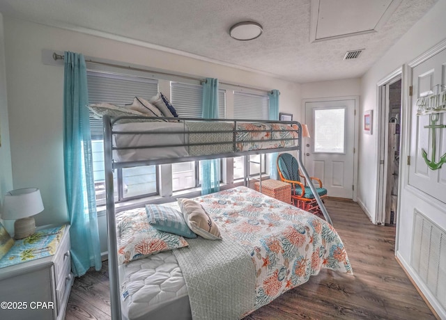 bedroom featuring hardwood / wood-style flooring and a textured ceiling