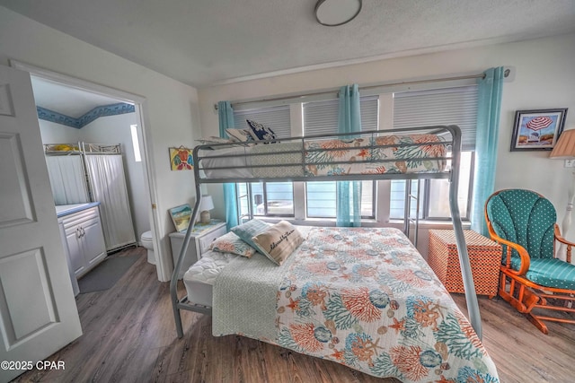 bedroom featuring hardwood / wood-style flooring and a textured ceiling