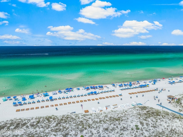 bird's eye view featuring a water view and a beach view