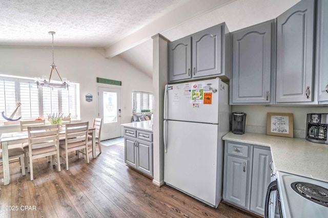 kitchen with dark hardwood / wood-style flooring, hanging light fixtures, white fridge, and gray cabinetry