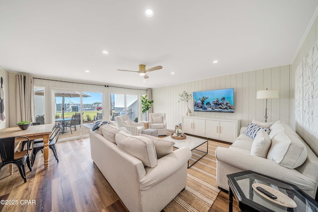 living area featuring a ceiling fan, wood finished floors, and recessed lighting