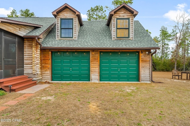 garage featuring a lawn