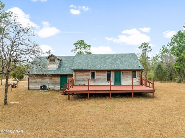 back of property featuring a wooden deck, a yard, and central AC