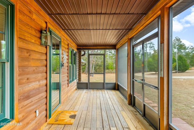 unfurnished sunroom featuring plenty of natural light and wooden ceiling