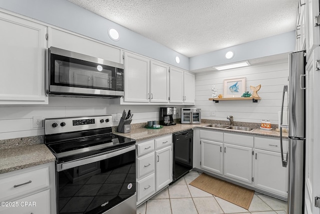 5801 Thomas Dr Unit 601, Panama City Beach, FL 32408 - kitchen featuring white cabinetry, stainless steel appliances, a textured ceiling, and a sink
