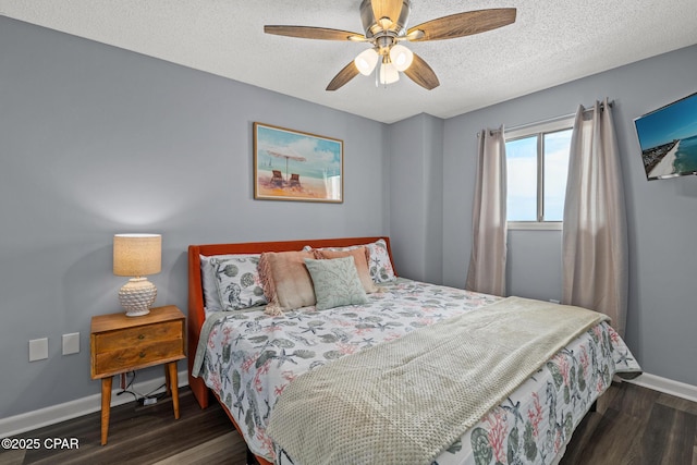 5801 Thomas Dr Unit 601, Panama City Beach, FL 32408 - bedroom featuring wood finished floors, a textured ceiling, baseboards, and ceiling fan