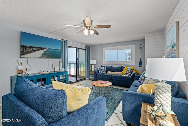 5801 Thomas Dr Unit 601, Panama City Beach, FL 32408 - living area featuring ceiling fan, tile patterned flooring, and a textured ceiling