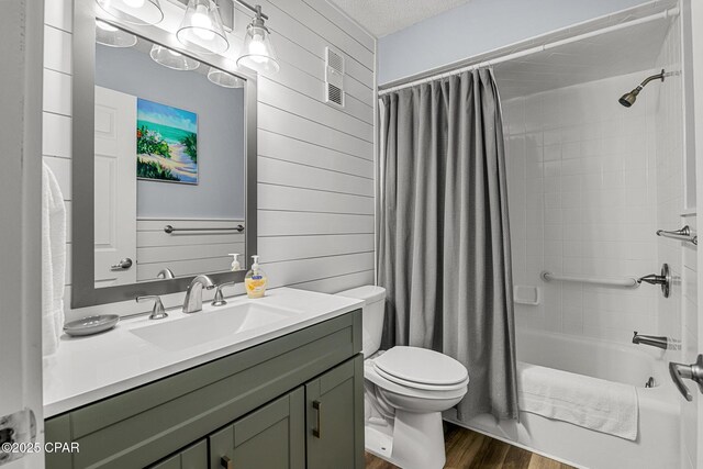 5801 Thomas Dr Unit 601, Panama City Beach, FL 32408 - bathroom featuring toilet, visible vents, shower / tub combo with curtain, wood finished floors, and vanity