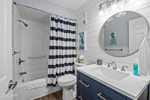 5801 Thomas Dr Unit 601, Panama City Beach, FL 32408 - bathroom featuring a textured ceiling, toilet, shower / tub combo, wood finished floors, and vanity