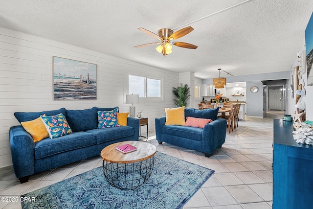 5801 Thomas Dr Unit 601, Panama City Beach, FL 32408 - living room with a ceiling fan, a textured ceiling, and light tile patterned flooring