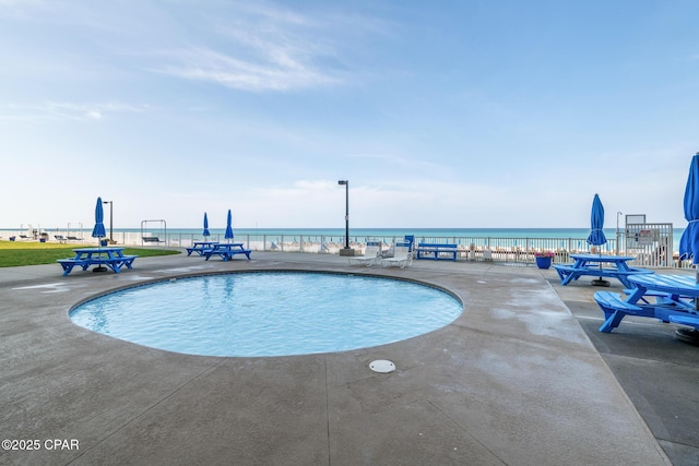 5801 Thomas Dr Unit 601, Panama City Beach, FL 32408 - community pool featuring a water view, a patio, and fence