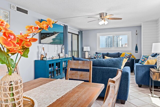 5801 Thomas Dr Unit 601, Panama City Beach, FL 32408 - tiled dining space featuring a ceiling fan, visible vents, and a textured ceiling