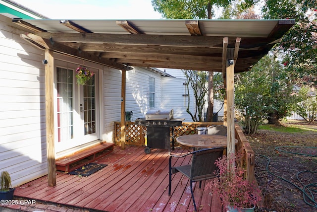 deck featuring outdoor dining space and area for grilling