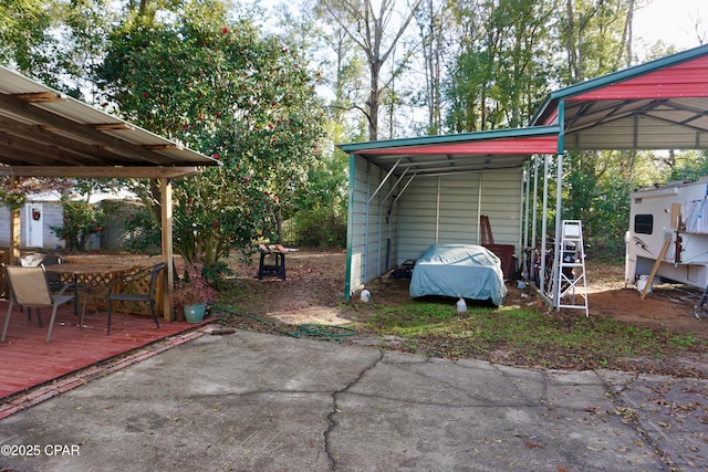 view of patio / terrace with a carport and driveway