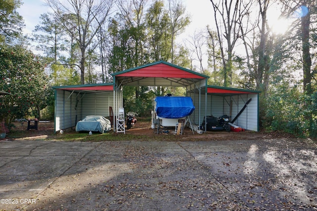 view of outbuilding with a detached carport and driveway