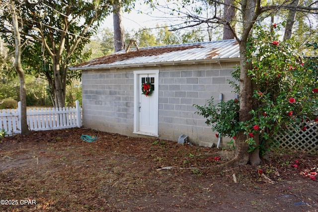 view of outbuilding with an outbuilding and fence