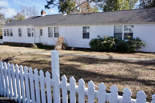 ranch-style house featuring a fenced front yard, crawl space, and a shingled roof