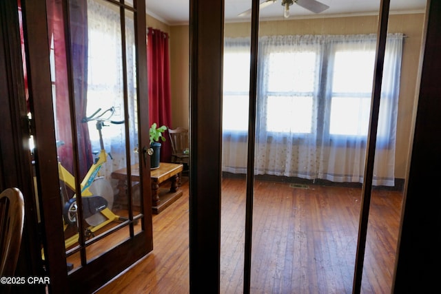 interior space featuring ornamental molding and hardwood / wood-style floors