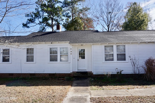 view of front of property featuring a shingled roof, entry steps, crawl space, and a chimney