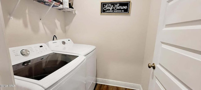 washroom featuring dark hardwood / wood-style floors and washing machine and clothes dryer