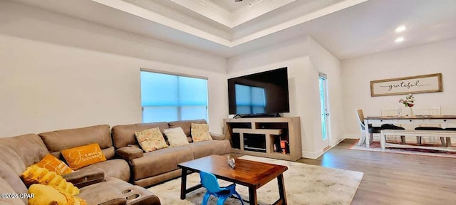 living room featuring hardwood / wood-style flooring and ornamental molding