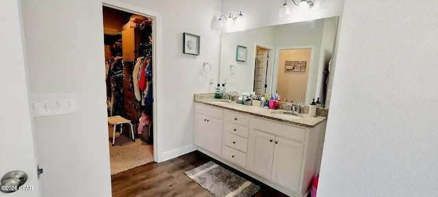 bathroom with vanity and hardwood / wood-style flooring