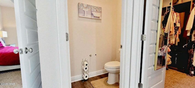 bathroom featuring hardwood / wood-style flooring and toilet