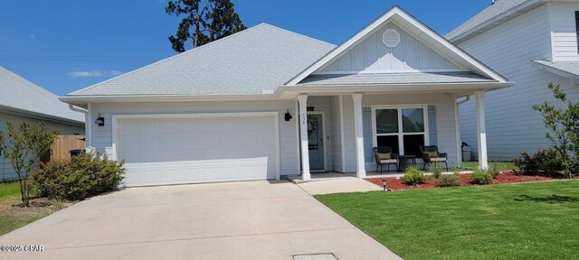 doorway to property with a garage and covered porch