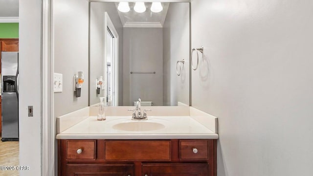 bathroom featuring ornamental molding and vanity