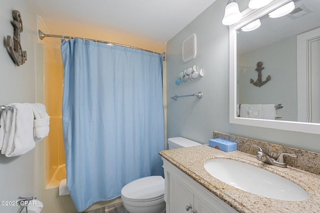 bathroom featuring vanity, visible vents, and toilet