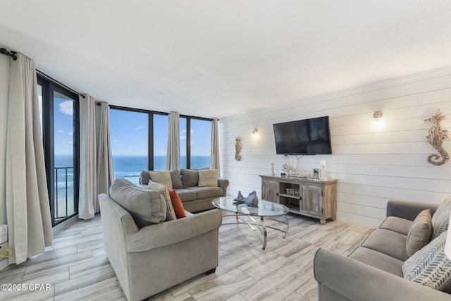 living room with expansive windows and light hardwood / wood-style floors