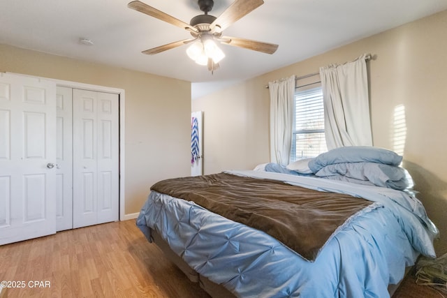 bedroom featuring ceiling fan, light wood-type flooring, and a closet