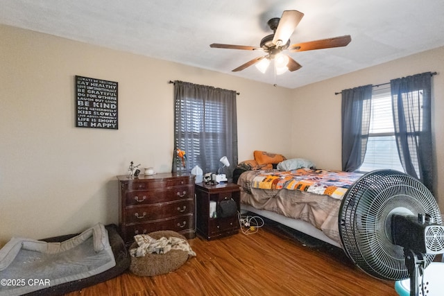 bedroom with hardwood / wood-style flooring and ceiling fan