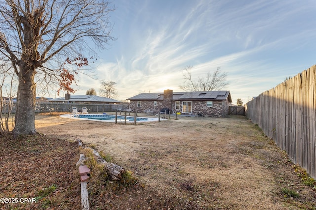 view of yard with a fenced in pool