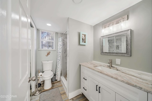 bathroom featuring hardwood / wood-style flooring, vanity, a shower with curtain, and toilet