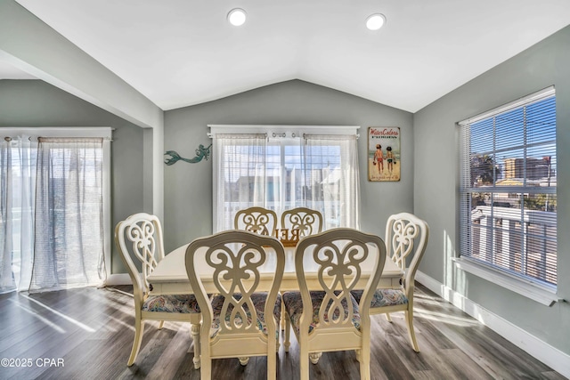 dining space with lofted ceiling and dark hardwood / wood-style flooring