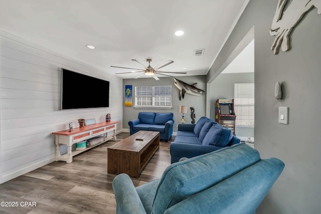 living room featuring hardwood / wood-style flooring and ceiling fan