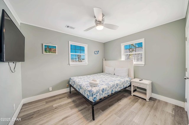 bedroom with ornamental molding, ceiling fan, and light hardwood / wood-style flooring