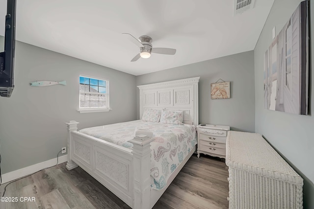 bedroom with dark hardwood / wood-style flooring and ceiling fan