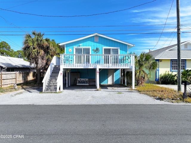 raised beach house featuring a carport