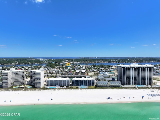 birds eye view of property featuring a water view and a beach view