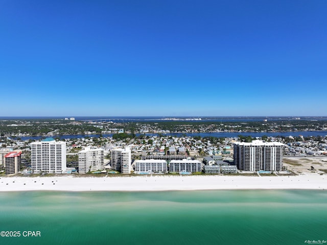 drone / aerial view featuring a water view and a view of the beach