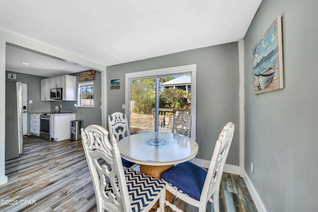 dining space with light hardwood / wood-style floors