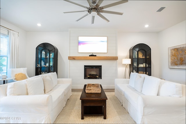 living area with recessed lighting, visible vents, a large fireplace, and a ceiling fan