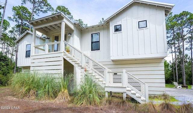 modern farmhouse featuring board and batten siding and stairs