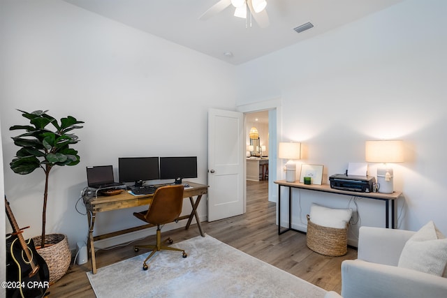 home office featuring visible vents, a ceiling fan, and light wood-style floors